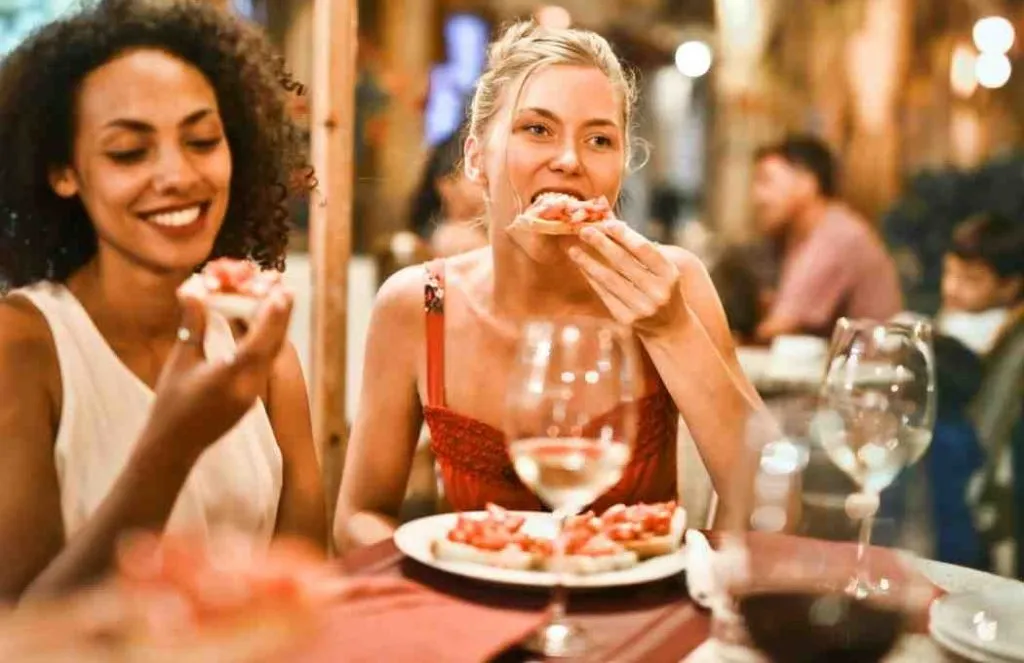 women eating appetizers with drinks